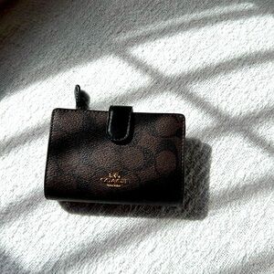 Elegant Coach Wallet with iconic pattern